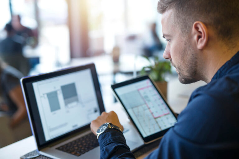 business-man-looking-analyzing-projects-his-laptop-computer-tablet (1)